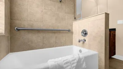 a white tub in a bathroom with a shower at Summer Deal - Relax & Unwind, Townhome by Disney! in Orlando