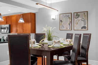 a dining room with a table and chairs at Sunny Summer Awaits - Renovated Townhome by Disney! in Orlando