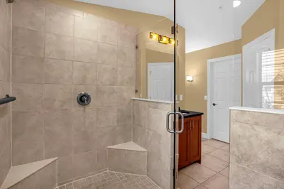 a bathroom with a shower with a glass door at Sunny Summer Awaits - Renovated Townhome by Disney! in Orlando