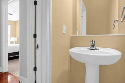 a bathroom with a white sink and a mirror at Sunny Summer Awaits - Renovated Townhome by Disney! in Orlando