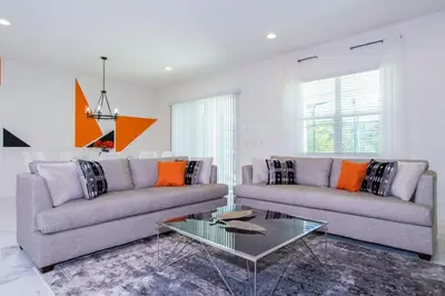 a living room with two couches and a glass table at Gorgeous Family Home! Sleeps 28 BLV103 in Kissimmee