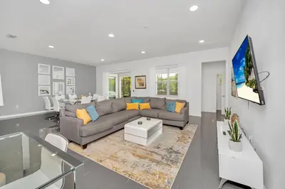 a living room with a couch and a tv at Vacation Paradise Home, Private Pool, Game Room BL102 in Kissimmee