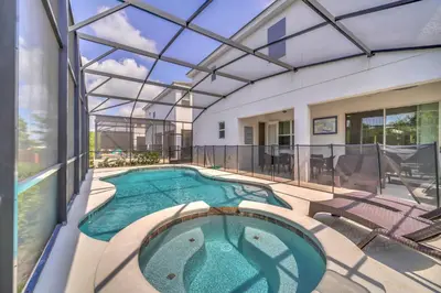 an indoor swimming pool with a glass ceiling at Vacation Paradise Home, Private Pool, Game Room BL102 in Kissimmee