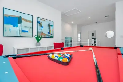 a red pool table with balls on top of it at Vacation Paradise Home, Private Pool, Game Room BL102 in Kissimmee