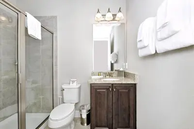 a bathroom with a toilet and a sink and a shower at Astounding Home Near Disney With Themed & Media Room, Pool Table With Waterpark & Resort Access At Encore Resorts Reunion - 240Cl in Kissimmee