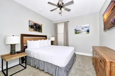 a bedroom with a bed and a ceiling fan at Astounding Home Near Disney With Themed & Media Room, Pool Table With Waterpark & Resort Access At Encore Resorts Reunion - 240Cl in Kissimmee