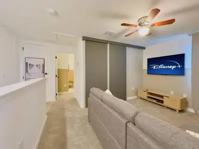 a living room with a couch and a ceiling fan at Modern 3BR3BA Home at The Hub Reserve in Kissimmee