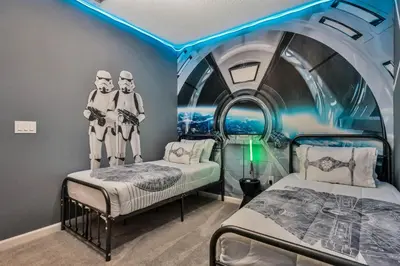 two beds in a room with blue lights at BV310MB - Disney & Universal heroes - 16 guests in Kissimmee