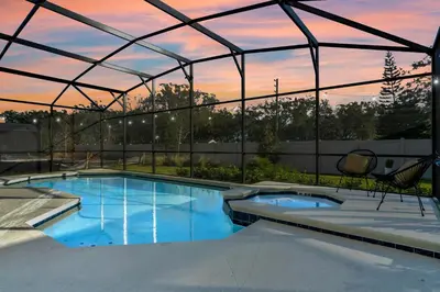 a large swimming pool with a tent in a backyard at BV310MB - Disney & Universal heroes - 16 guests in Kissimmee