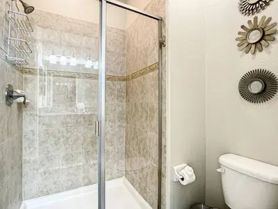 a bathroom with a shower and a toilet at Paradise Palms Resort Townhome Close to Disney in Kissimmee