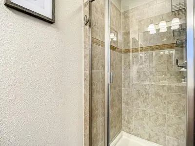 a shower with a glass door in a bathroom at Paradise Palms Resort Townhome Close to Disney in Kissimmee