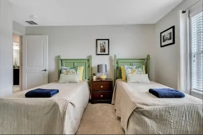 a bedroom with two beds with pillows on them at StoreyLake Disney Pool Home, Lake View, By Disney in Kissimmee