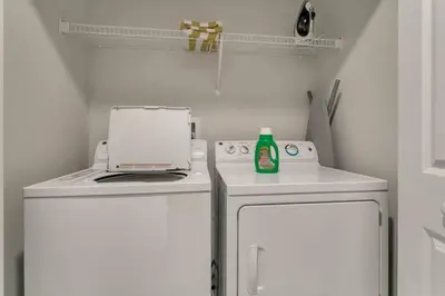 a kitchen with a stove and a white refrigerator at StoreyLake Disney Pool Home, Lake View, By Disney in Kissimmee