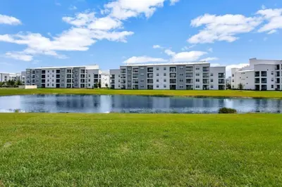 a large lake in front of some apartment buildings at StoreyLake Disney Pool Home, Lake View, By Disney in Kissimmee