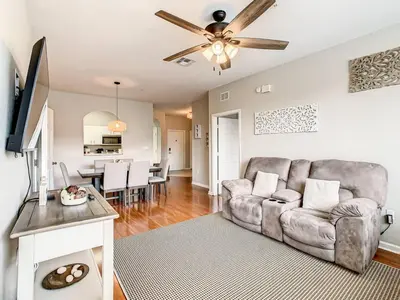 a living room with a couch and a ceiling fan at Windsor Hills Mickey Mouse Condo, 2.5mi Disney in Orlando