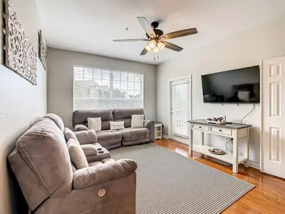 a living room with a couch and a ceiling fan at Windsor Hills Mickey Mouse Condo, 2.5mi Disney in Orlando