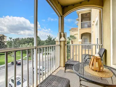 a balcony with a table and chairs and a view of a street at Windsor Hills Mickey Mouse Condo, 2.5mi Disney in Orlando