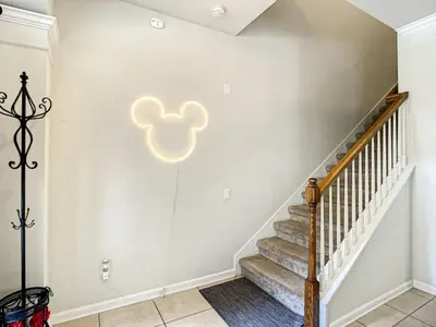 a staircase in a home with a white wall at Windsor Hills Themed Home Pool Spa 2.5mi Disney in Orlando