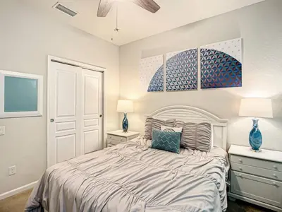 a bedroom with a bed with two night stands and two lamps at Windsor Hills Themed Home Pool Spa 2.5mi Disney in Orlando