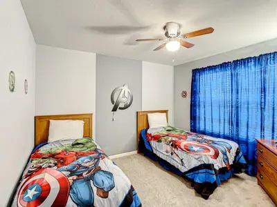 a bedroom with two beds and a ceiling fan at Windsor Hills Themed Home Pool Spa 2.5mi Disney in Orlando