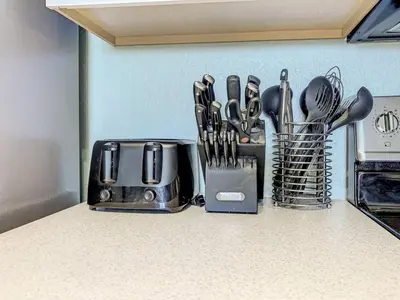 a kitchen counter with utensils on a counter top at Windsor Hills Themed Condo, 2.5mi to Disney in Orlando