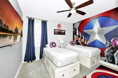 two beds in a room with a captain america mural at Stylish Home With Private Pool, Themed And Game Room With Waterpark & Resort Access Near Disney At Encore Resorts Reunion - 300Bu in Kissimmee