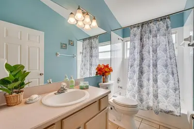 a bathroom with a sink and a toilet at 4 Mi to Disney Spacious Retreat with Pool and Yard! in Kissimmee