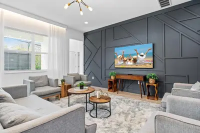 a living room with a tv on a wall at Big Family Home with Game Room Sleeps 28 BLV104 in Kissimmee