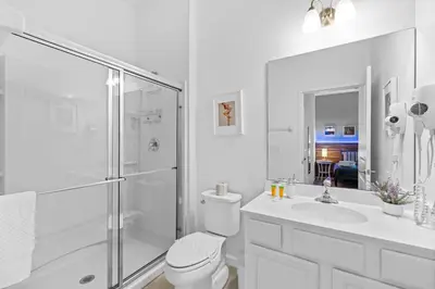 a white bathroom with a shower and a toilet at Big Family Home with Game Room Sleeps 28 BLV104 in Kissimmee