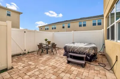 a patio with a table and a fence at Comfy House at Compass Bay CB102 in Kissimmee
