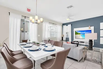 a living room with a white table and chairs at Comfy House at Compass Bay CB102 in Kissimmee