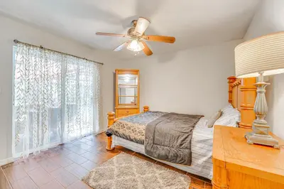 a bedroom with a bed and a ceiling fan at Orlando-Area Family Oasis with Lanai, Pool and Yard in Orlando