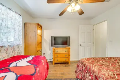 a bedroom with a bed and a television on a dresser at Orlando-Area Family Oasis with Lanai, Pool and Yard in Orlando