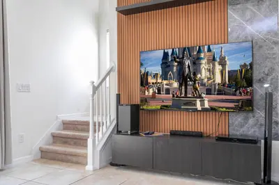 a living room with a flat screen tv on a wall at Perfect Themed 3 BD Hot tub renovated - 3013 in Kissimmee