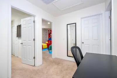 a dining room with a table and a bedroom at Perfect Themed 3 BD Hot tub renovated - 3013 in Kissimmee