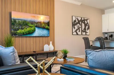 a living room with a painting on the wall at 4Bd Close to Disney with Pool at Storey Lake 2560 in Kissimmee