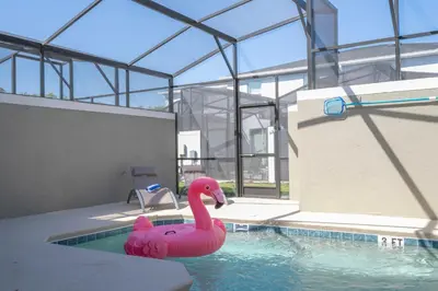 a pink inflatable pink flamingo in a swimming pool at 4Bd Close to Disney with Pool at Storey Lake 2560 in Kissimmee