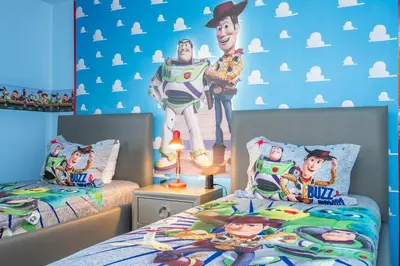 a bedroom with two beds and a mural of a movie at 4Bd Close to Disney with Pool at Storey Lake 2560 in Kissimmee
