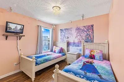 a childs bedroom with two beds and a window at 7BDM Prvt Pool Villa - Gated Resort 10min to Disney in Kissimmee