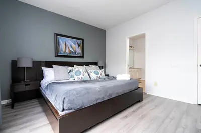 a bedroom with a large bed with blue walls at 5* House 5* Resort Orlando. Location location location in Orlando