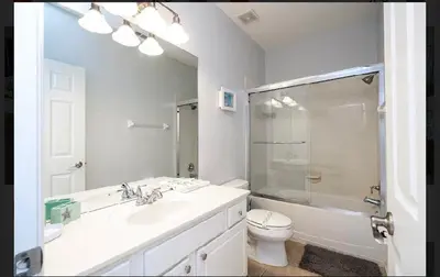 a bathroom with a toilet and a sink and a shower at 5* House 5* Resort Orlando. Location location location in Orlando