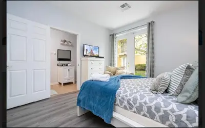 a bedroom with a bed and a dresser and a television at 5* House 5* Resort Orlando. Location location location in Orlando