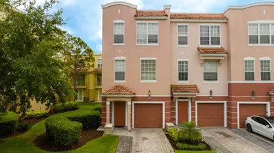 a large pink building with two garage doors at 5* House 5* Resort Orlando. Location location location in Orlando