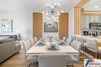 a dining room and living room with a table and chairs at The Epic Toronto Vista Cay Orlando in Orlando