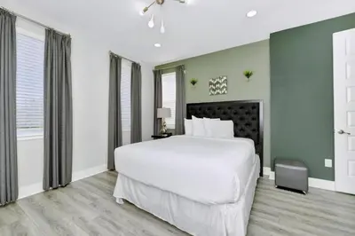 a bedroom with a large white bed and green walls at Elegant Home Near Disney With Game & Themed Rooms With Waterpark & Resort Access At Encore Resorts Reunion - 400La in Kissimmee