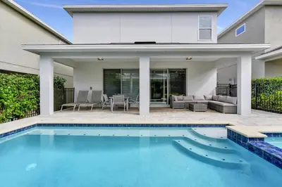 a swimming pool in front of a house at Elegant Home Near Disney With Game & Themed Rooms With Waterpark & Resort Access At Encore Resorts Reunion - 400La in Kissimmee