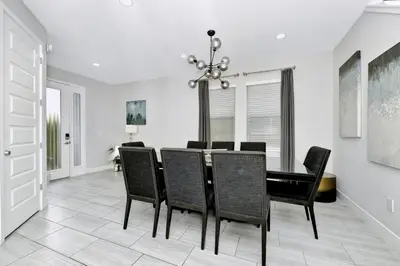 a dining room with a table and chairs at Elegant Home Near Disney With Game & Themed Rooms With Waterpark & Resort Access At Encore Resorts Reunion - 400La in Kissimmee
