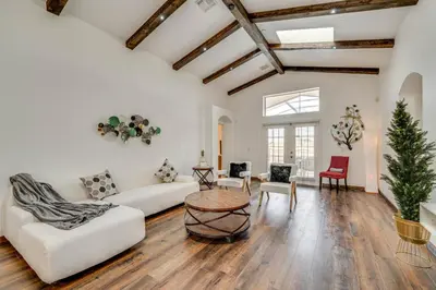 a living room with white furniture and a christmas tree at Renovated Kissimmee Home - 10 Mi to Disney Springs in Kissimmee