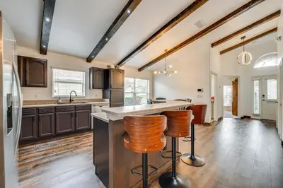 a kitchen with a counter and two bar stools at Renovated Kissimmee Home - 10 Mi to Disney Springs in Kissimmee