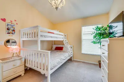 a childs bedroom with a white bunk bed at Renovated Kissimmee Home - 10 Mi to Disney Springs in Kissimmee